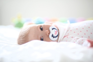 Photo of a baby awake in bed