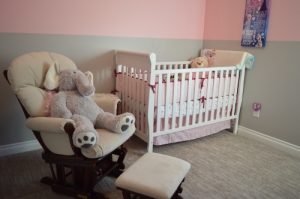 Photo of a comfortable armchair near a baby bed